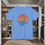 Thumbnail: blue t-shirt Old Dudes Club over a beach theme circular back ground