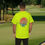 Thumbnail: safety green t-shirt Old Dudes Club over a beach theme circular back ground