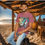 Thumbnail: gray tee shirt with a colorful beach and palm tree image with an old Corvette and an older guy wearing a Hawaiian shirt