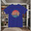 Thumbnail: blue t-shirt Old Dudes Club over a beach theme circular back ground