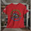 Thumbnail: red tee with a graphic of a fish jumping with Catching Dreams printed in arching green letters with Old Dudes Fishing Club