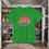 Thumbnail: green t-shirt Old Dudes Club over a beach theme circular back ground