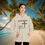 Thumbnail: sand hoodie with Godfidence, Knowing I Can't But He can printed in black with large 3 nail style cross