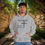 Thumbnail: gray hoodie with Godfidence, Knowing I Can't But He can printed in black with large 3 nail style cross