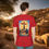 Thumbnail: RED TEE SHIRT WITH A COLORFUL SKY WITH GLOWING RAYS OF SUNSHINE BEHIND A CROSS