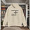 Thumbnail: sand hoodie with Godfidence, Knowing I Can't But He can printed in black with large 3 nail style cross