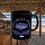 Thumbnail: Black coffee mug with a blue fish in the center, Fish Relax Enjoy arching above and Old Dudes Club printed in blue below