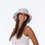 Thumbnail: Smiling young woman wearing a colorful tie-dye bucket hat, looking radiant.
