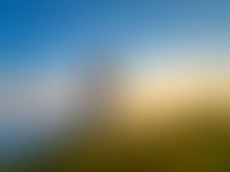 A man hiking uphill on a grassy mountain ridge at sunrise, using trekking poles for support, surrounded by clouds and golden sunlight — symbolizing perseverance, focus, and progress toward goals.