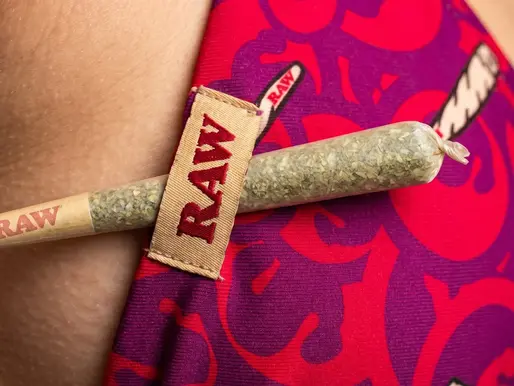 A detailed close-up of the bikini top showing the branded tag and fabric pattern.