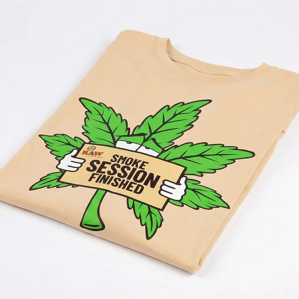 Tan T-shirt with a cartoon green leaf holding a sign that reads "RAW Smoke Session Finished." White background. Playful mood.
