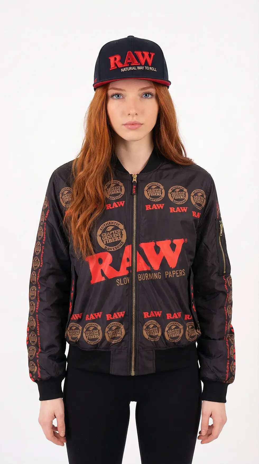 Woman with red hair wears a black jacket and cap with "RAW" logos. The mood is neutral. Background is plain white.