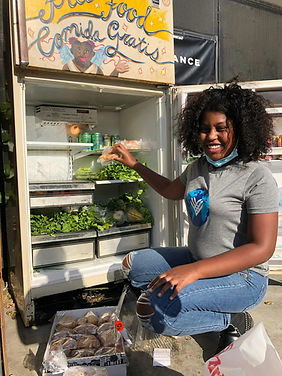 Young woman stocking Community Fridge
