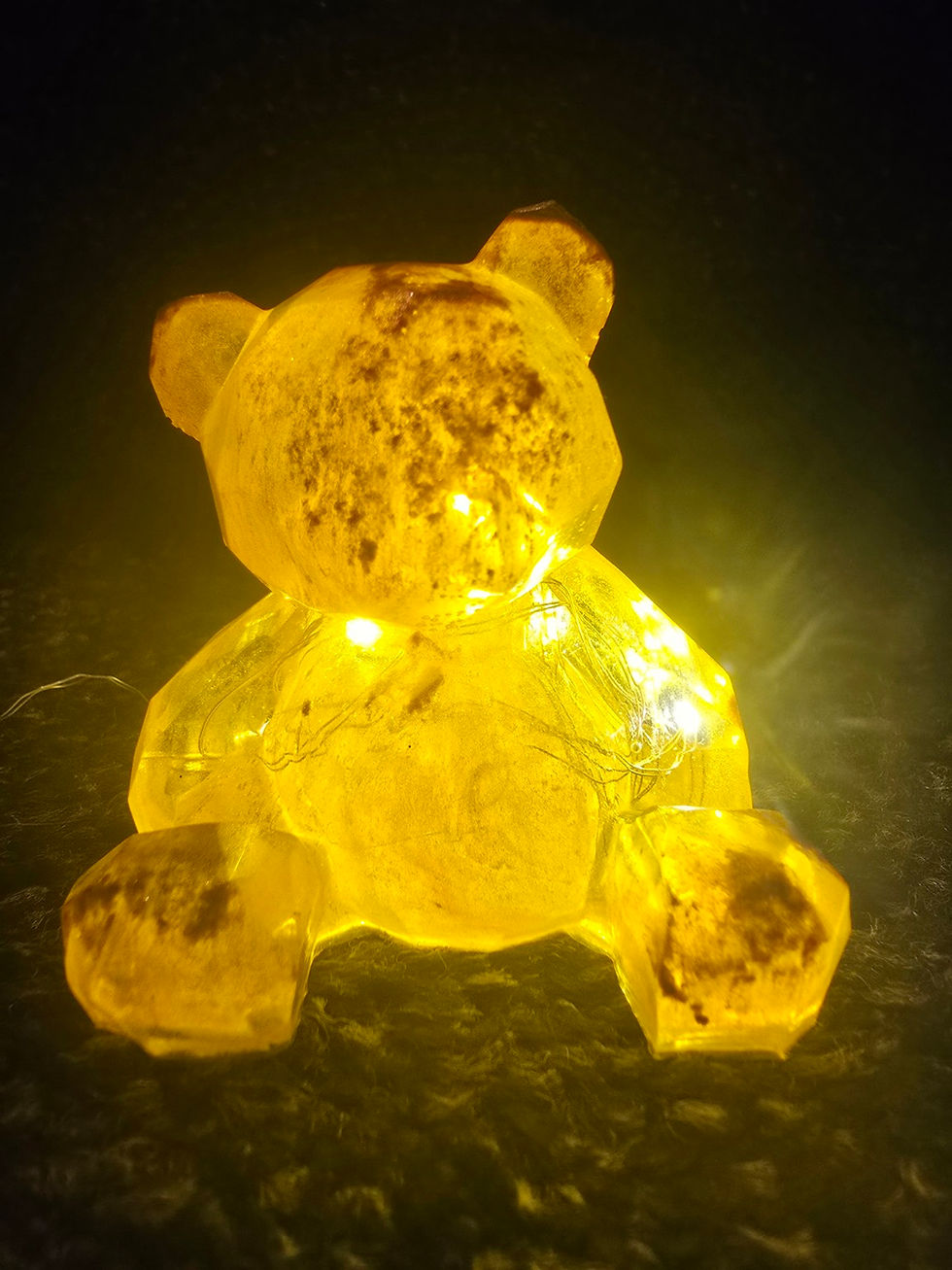 Yellow geometric resin bear with warm LED lights inside, handcrafted with a smooth faceted design.