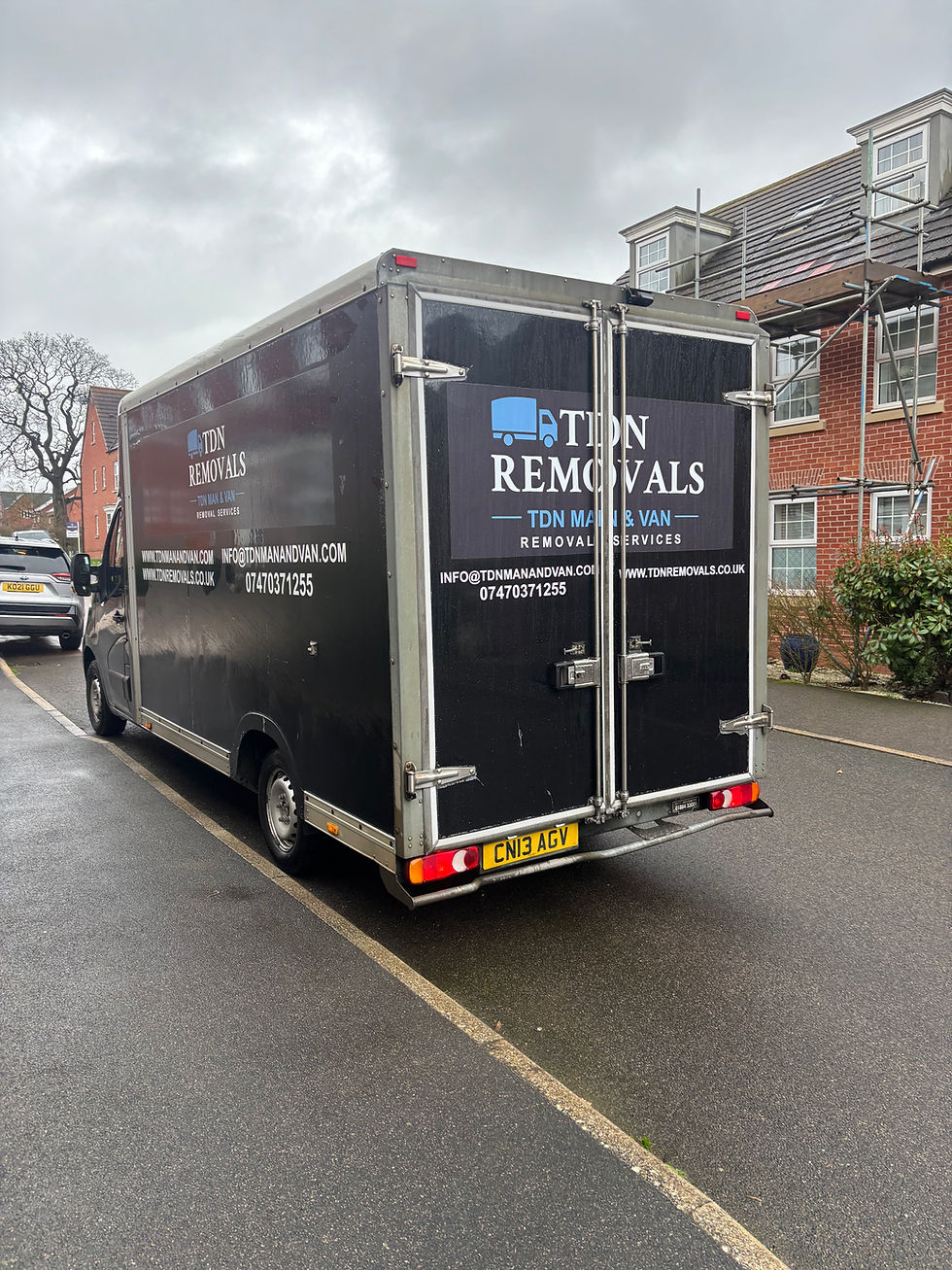 Close-up view of a van’s open back door with neatly packed boxes inside