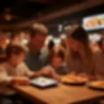 Restaurant digital menu board displaying vibrant food photography and daily specials above the counter, with customers engaged in ordering decisions