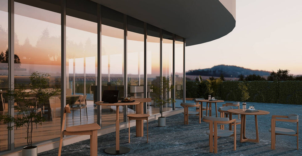 Terraza exterior del SCALA Lifestyle and Business Center con mobiliario de madera y vista al atardecer.