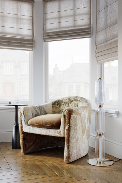 a chair in front of a window with a lamp next to it, , luxury interior design Edinburgh
