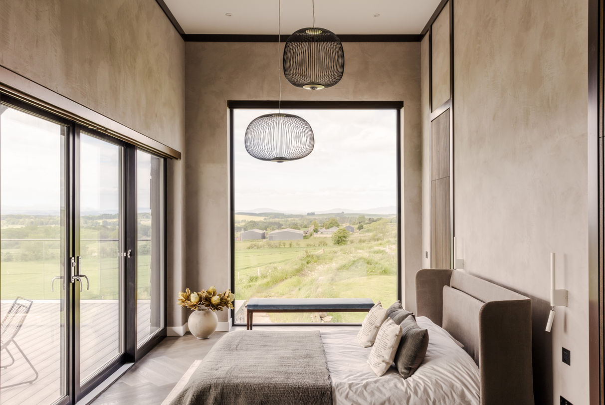 a bedroom with a large window and a large bed