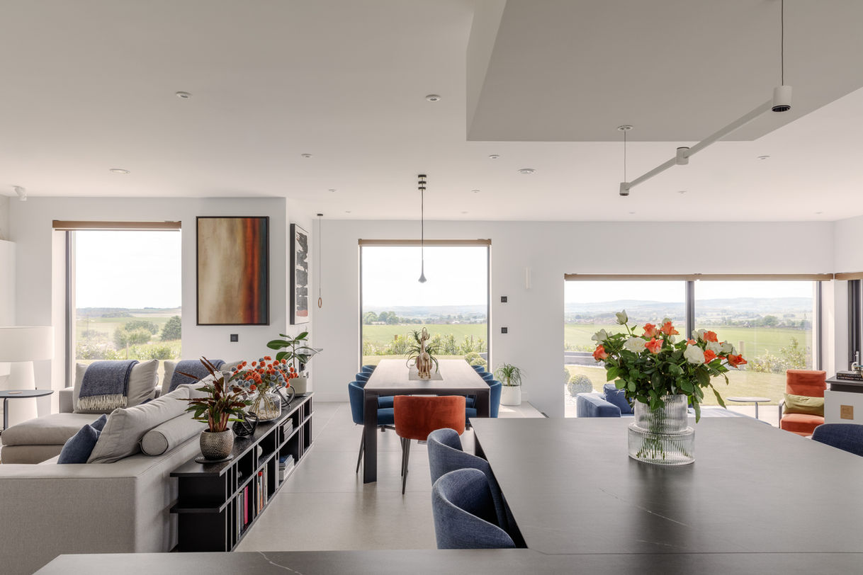 a dining room table with a vase of flowers on it