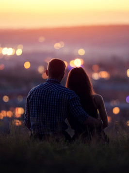 couple watching sunset over city