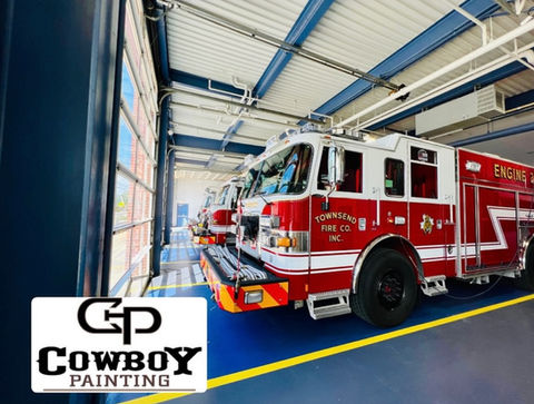 Fire station with fire trucks parked on a durable, slip-resistant industrial epoxy-coated floor, designed for safety and longevity.