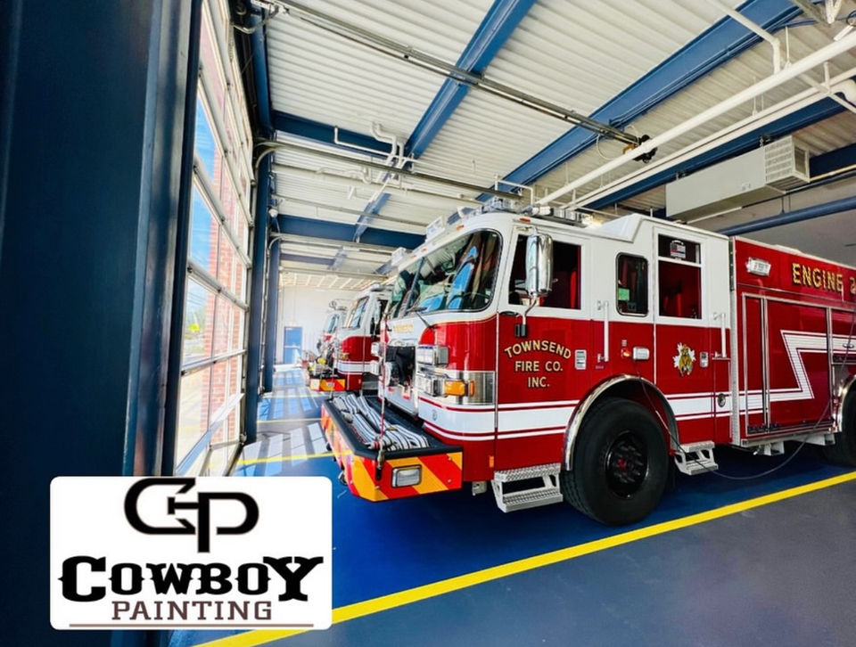 Fire station with fire trucks parked on a durable, slip-resistant industrial epoxy-coated floor, designed for safety and longevity.