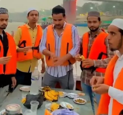 Men in orange life vests having Iftar on a boat