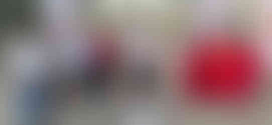 Group of officials holding a sign at an event in Koppal