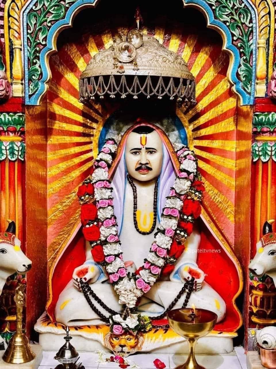 Seated spiritual figure adorned with garlands