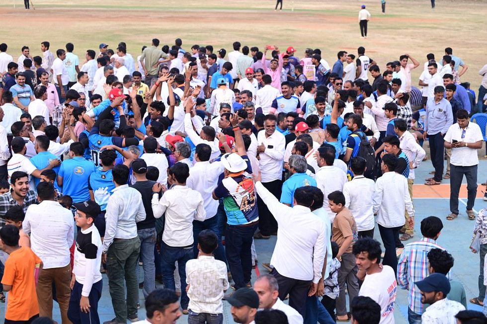 Excited crowd celebrating on a cricket ground