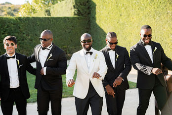 A lively shot of the groom and groomsmen walking and dancing outside Casa dos Penedos
