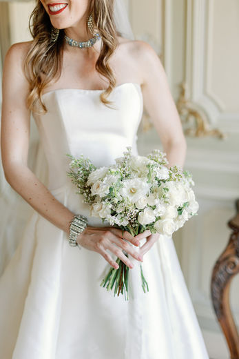 Close-up portrait of the bride emphasizing her red lips and bouquet
