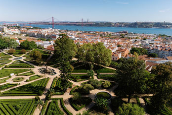 An aerial view of the Jardim Botânico da Ajuda, with the Tejo River unfolding in the background, connecting the wedding setting to the wider Lisbon landscape