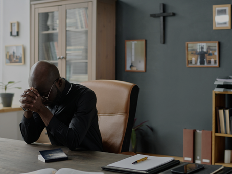 Pastor sitting alone in quiet reflection