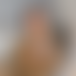 Woman holding a cup of cordyceps coffee at her kitchen table in the morning