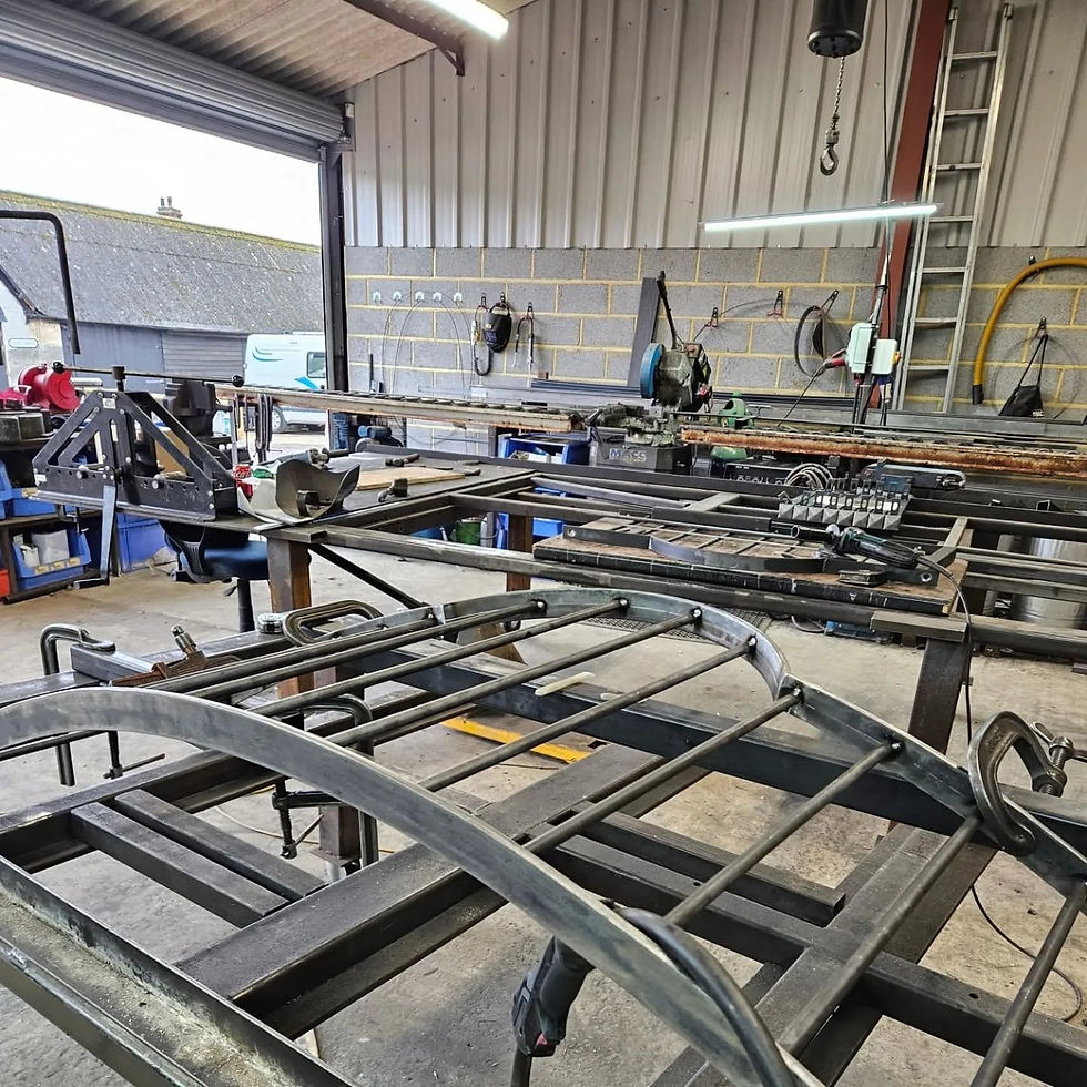 Steel chassis frames under construction on a workbench in a metal fabrication workshop
