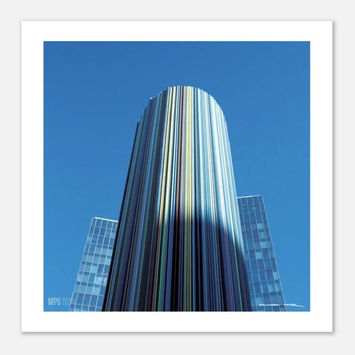 Low-angle color photograph of a modern striped skyscraper reaching into a clear blue sky