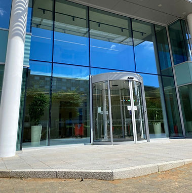Glass revolving door at the entrance of a modern office building