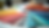 Close-up view of colorful fabric swatches and paint samples on a table