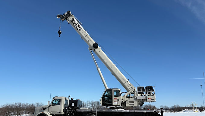 30-Second Takeaway National Crane , part of Manitowoc , has launched the NTC80 boom truck at CONEXPO 2026 , delivering 80 USt lifting capacity with a 156 ft five-section telescopic boom . Designed using direct customer feedback, the crane combines higher lifting capability with the mobility of a commercial roadable truck chassis , making it well suited for utility, construction and oil and gas applications . National Crane Introduces New High-Capacity Boom Truck National Crane has unveiled the NTC80 boom truck at CONEXPO-CON/AGG 2026 in Las Vegas , expanding its boom truck portfolio with a higher-capacity model designed for roadable lifting operations. The new crane delivers 80 USt lifting capacity while maintaining the mobility and productivity required for projects that involve frequent travel between job sites . According to Bob Ritter, Director of Product Management at Manitowoc , the crane was developed directly from customer feedback. “The message we heard from customers was straightforward,” Ritter explained. “They needed more lifting capability, but the cranes still had to stay roadable and operate efficiently.” Designed for Frequent Jobsite Moves The NTC80 boom truck was engineered for sectors where cranes must be moved and set up repeatedly throughout the workday. Typical applications include: Utility infrastructure work Construction projects Oil and gas operations The crane combines high lifting capacity with easy transportability , allowing crews to move quickly between lifting tasks without sacrificing productivity. Telescopic Boom and Jib System The NTC80 features a 156 ft (47.5 m) five-section telescopic boom , significantly expanding lifting reach compared with previous boom truck models. To further extend reach, the crane can be equipped with a bi-fold swing-away jib measuring: 37 ft to 61 ft The jib can be positioned at 0°, 15° or 30° offsets , providing flexibility when working around structures or complex lift geometries. The crane also includes electric pinning , allowing faster deployment and stowage of the jib system. Modular Counterweight System Improves Transportability A trayless modular counterweight system allows operators to configure the crane depending on job requirements and chassis specification. Available counterweight packages include: 12,000 lb standard configuration 18,000 lb heavy roadable configuration 24,000 lb maximum counterweight setup Counterweight slabs can be stacked in any order and removed hydraulically , helping crews optimise lifting capacity while maintaining roadability. Flexible Outrigger Setup for Tight Job Sites The NTC80 includes four-position outriggers with a 24 ft full-span setup . For work in restricted areas, operators can also use an optional single front outrigger configuration , improving versatility on congested construction sites. These features allow the crane to operate effectively in urban or infrastructure environments where space is limited . Operator Comfort and Improved Visibility National Crane has introduced an all-new operator cab on the NTC80. Key improvements include: Increased interior space and legroom Improved operator visibility Ergonomic controls for easier operation The boom tip also includes safety and visibility features such as: External anti-two-block (A2B) cable Optional electric boom lights Optional aircraft beacon warning light These systems help improve jobsite awareness and operational safety. Designed for Serviceability and Technician Access The NTC80 boom truck was designed with simplified maintenance in mind. Service features include: Lockable ladder storage on both sides of the crane Multiple ladder access points Pull-out catwalk accessible from the operator cab Integrated hoist access platform These features make routine inspections and servicing easier for technicians working in the field. Supporting Infrastructure Work Across North America The launch of the NTC80 reflects Manitowoc’s continued focus on supporting infrastructure and industrial projects across North America. Through its global dealer network and aftermarket support programs, Manitowoc provides: Rapid spare parts availability Technical service support Lifecycle maintenance services The company says the NTC80 reflects its “Big and Bold” product development strategy , focusing on equipment designed for real-world jobsite requirements. About National Crane National Crane , part of The Manitowoc Company , manufactures boom trucks and truck-mounted cranes used across construction, utility, energy and infrastructure industries worldwide. Website: https://www.manitowoc.com Frequently Asked Questions What is the lifting capacity of the National Crane NTC80? The National Crane NTC80 has a maximum lifting capacity of 80 USt (approximately 72 tonnes) . What is the boom length of the NTC80? The crane features a 156 ft five-section telescopic boom . What jib options are available on the NTC80? The crane can be fitted with a 37 ft to 61 ft bi-fold swing-away jib with 0°, 15° or 30° offsets . What industries is the NTC80 designed for? The crane is designed for utility, construction and oil and gas applications where cranes must move frequently between job sites. Where was the NTC80 first unveiled? The crane was introduced at CONEXPO-CON/AGG 2026 in Las Vegas .