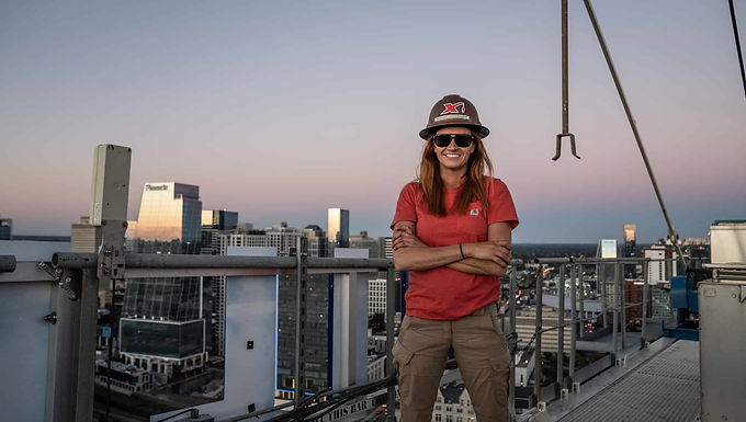 30 Second Takeaway Tower crane operator Sammy Cossairt has been named the National Association of Women in Construction (NAWIC) 2025 Tradeswoman of the Year , recognizing her exceptional skill, leadership, and advocacy for women in the trades. From shaping Nashville’s skyline with Maxim Crane Works to mentoring the next generation and using her voice beyond the job site, Sammy continues to raise the bar for what’s possible in construction. Shaping the Skyline One Lift at a Time If you look across Nashville’s growing skyline, there’s a strong chance Sammy Cossairt played a role in bringing it to life. As a Tower Crane Operator with Maxim Crane Works , Sammy spends her days hundreds of feet above active job sites, operating one of the most demanding and high-responsibility machines in construction. It’s a role that requires constant focus, trust in the team below, and the ability to perform under pressure qualities that have come to define her career. Now, that dedication has earned her one of the industry’s most prestigious recognitions. A National Honor for Excellence in the Trades In 2025, Sammy was named NAWIC’s National Tradeswoman of the Year , a top honor awarded to women who demonstrate outstanding technical ability, leadership, mentorship, and commitment to advancing the construction industry. The recognition followed her earlier selection as NAWIC Nashville Tradeswoman of the Year , where her peers first acknowledged the impact she has made locally both on the job site and within the community. These awards place Sammy among a select group of tradeswomen whose work and leadership are helping redefine the future of construction. Leading by Example at Maxim Crane Works At Maxim Crane Works , Sammy is widely regarded not only for her precision as an operator, but also for the example she sets for others entering the field. Her colleagues describe her as a role model someone who leads with professionalism, calm under pressure, and a willingness to mentor those around her. Through her presence on site, she has helped make crane operating feel more accessible to women considering careers in the trades. “Operating a crane takes focus, grit, and trust,” Sammy says. “But it’s also about lifting others whether that’s building the skyline or encouraging the next generation of tradeswomen.” Recognition Beyond the Job Site Sammy’s influence extends beyond daily operations. In addition to her NAWIC honors, she was recently named Crane Hub Magazine’s Blue Collar Hero of the Month , a recognition reserved for individuals who exemplify dedication, resilience, and pride in skilled trades. Each acknowledgment reflects a different facet of her impact technical excellence, leadership, and advocacy all grounded in a genuine passion for the work. Using Her Voice to Inspire Beyond cranes, Sammy has found another way to connect with and inspire others. This fall, she plans to release her original song, “Tradeswoman,” an anthem celebrating women in the trades and reflecting her own journey in a traditionally male-dominated industry. Through music, she hopes to reach audiences who may never have considered construction as a viable or welcoming career path. It’s another example of how Sammy continues to broaden the conversation around representation, confidence, and opportunity. Raising the Bar for What’s Possible With three major honors in a single year NAWIC Nashville Tradeswoman of the Year , Crane Hub’s Blue Collar Hero of the Month , and NAWIC’s National Tradeswoman of the Year . Sammy Cossairt’s story stands as proof of what can happen when skill, perseverance, and purpose align. More than lifting loads, she’s lifting expectations and helping shape an industry where more people can see themselves belonging. Congratulations, Sammy. You’re not just raising cranes you’re raising the standard for the entire industry. About NAWIC The National Association of Women in Construction (NAWIC) is a professional organization dedicated to advancing women in the construction industry. Founded in 1953, NAWIC provides education, professional development, mentorship, and networking opportunities to support women across all sectors of construction. Through advocacy, community engagement, and initiatives such as Women in Construction Week, NAWIC works to increase representation, foster leadership, and promote career growth for women in the skilled trades and construction professions. Website https://www.nawic.org