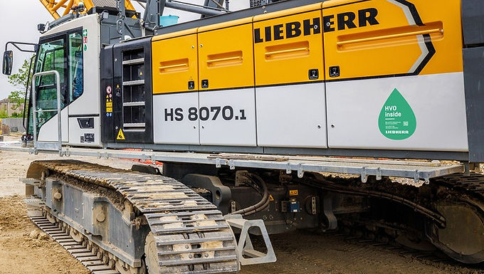 30 Second Takeaway Since August 2024, Liebherr-Werk Nenzing GmbH has converted its production operations to HVO fuel , replacing fossil diesel in the machines it manufactures and operates. The switch to Hydrotreated Vegetable Oil (HVO) reduces direct CO₂ emissions at the Austrian site by approximately 20 per cent , while extending emissions reductions into the logistics supply chain through HVO-powered transport operations. HVO fuel introduced across production at Liebherr-Werk Nenzing Liebherr-Werk Nenzing GmbH , based in Nenzing, Austria , has transitioned to HVO fuel for the machines produced and operated at its manufacturing facility. The conversion has been in effect since August 2024 and represents a significant step toward reducing greenhouse gas emissions associated with crane and construction machinery production. Unlike fossil diesel, HVO fuel is largely CO₂-neutral during combustion and can be used directly in conventional combustion engines without modification. This allows existing machinery to operate immediately with reduced emissions. What is HVO fuel and how it reduces emissions HVO (Hydrotreated Vegetable Oil) is a synthetically produced fuel derived primarily from vegetable oils , animal fats , and waste oils from the food industry. These raw materials are converted into hydrocarbons through a hydrogen treatment process. The HVO fuel used at Liebherr’s Nenzing site is supplied by Neste and is free from palm oil . Compared to conventional diesel, this fuel can reduce CO₂ emissions by up to 90 per cent during combustion , depending on the application and blending ratio. At the Nenzing facility, the conversion to HVO fuel is expected to: Save approximately 300,000 litres of diesel per year Reduce CO₂ emissions by around 810 tonnes annually Deliver a 20 per cent reduction in direct site emissions Because HVO can be mixed with fossil diesel in any proportion, emissions savings increase as the HVO share in the fuel mix rises. HVO in logistics extends emissions reduction to supply chain In addition to production operations, Liebherr-Werk Nenzing GmbH has extended the use of HVO fuel into its logistics activities. Since early August 2024, all transport operations serving the site have been carried out by a Vorarlberg-based transport company using HVO-powered vehicles . This change significantly reduces emissions associated with inbound and outbound logistics, delivering: A 23 per cent reduction in transport-related emissions Savings of approximately 3,500 tonnes of CO₂ By converting both production equipment and transport operations, the Nenzing site is addressing emissions across multiple stages of its operational footprint. HVO compatibility across Liebherr machine fleets A key advantage of HVO fuel is its compatibility with conventional combustion engines , allowing immediate deployment across a wide range of machinery. As a result, most Liebherr machines in the global fleet can operate with HVO fuel without technical modification. This compatibility supports broader adoption of low-emission fuels across construction sites, industrial operations, and logistics networks where full electrification may not yet be feasible. About Liebherr-Werk Nenzing GmbH Liebherr-Werk Nenzing GmbH , located in the Austrian Alps, specialises in the development and production of construction machinery for demanding applications. The site manufactures crawler cranes , hydraulic rope excavators , and piling and drilling rigs , supplying customers worldwide. The Nenzing facility plays a central role in Liebherr’s crawler crane production and supports ongoing development of digital solutions and services for modern construction sites. The transition to HVO fuel reflects site-level initiatives aimed at reducing operational emissions while maintaining production efficiency. About Neste Neste develops renewable fuels and circular raw materials using waste-based and renewable feedstocks. The company focuses on transforming waste oils and residues into renewable diesel , sustainable aviation fuel , and circular solutions that support emissions reduction across transport, industry, and logistics sectors. Frequently Asked Questions What is HVO fuel? HVO (Hydrotreated Vegetable Oil) is a renewable fuel produced from vegetable oils, animal fats, and waste oils, offering significantly lower CO₂ emissions than fossil diesel. Why did Liebherr-Werk Nenzing switch to HVO fuel? The conversion reduces direct CO₂ emissions , lowers fossil fuel consumption, and allows existing machinery to operate with reduced environmental impact. How much CO₂ does the conversion save? The switch saves approximately 810 tonnes of CO₂ per year at the Nenzing site, equating to a 20 per cent reduction in direct emissions . Can HVO be used in conventional diesel engines? Yes. HVO fuel can be used in standard combustion engines and mixed with fossil diesel in any ratio. How does HVO affect logistics emissions? Using HVO-powered transport vehicles reduces logistics-related emissions by around 23 per cent , saving approximately 3,500 tonnes of CO₂ .logy to transform waste and other resources into renewable fuels and circular raw materials; helping you act now, to meet your sustainability goals.