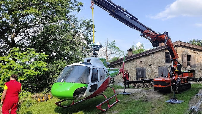 30 Second Takeaway Italian crane rental specialist Bendini Gru has successfully completed a complex helicopter recovery operation in the Tuscan-Emilian Apennines, using a 15.5-tonne Jekko JF545 spider crane. The operation highlights the advantages of compact, high-capacity spider cranes in remote, unstable terrain where conventional lifting methods are impractical. Emergency Landing in Difficult Terrain The recovery followed an emergency landing involving an Elifiulia Helicopter Service aircraft travelling from Ronchi dei Legionari (Friuli Venezia Giulia) to Garfagnana for firefighting operations. Adverse weather conditions and low cloud cover caused the pilots to lose visual reference, forcing an immediate landing to avoid collision with mountainous terrain or nearby power lines. The helicopter measuring 12 metres by two metres and weighing approximately two tonnes came to rest on steep ground affected by instability following recent severe weather across the Emilia-Romagna region. Selecting the Right Recovery Method Bendini Gru assessed several recovery options, including: Lifting and transporting the aircraft using a larger helicopter Deploying a truck-mounted crane Organising a relay of vehicles, including tractors, truck mounts, and mini cranes After careful evaluation, the company selected the Jekko JF545 spider crane as the safest and most efficient solution, due to its compact footprint, lifting capability, and adaptability to unstable ground conditions. Why the Jekko JF545 Was Chosen The Jekko JF545 offered the ideal balance of reach, capacity, and mobility for the site conditions. Key specifications include: Maximum tip height: over 30 metres Capacity: 2.5 tonnes at 16 metres Maximum radius: 28 metres (600 kg) Operating weight: 15,500 kg Overall width: 1.84 metres Overall length: 5.4 metres Outriggers: five-stage variable stability system Its compact dimensions and variable outrigger setup allowed safe positioning on uneven and softened ground. Recovery Operation Execution The recovery team transported the spider crane approximately three kilometres along dirt tracks and steep terrain using a tractor. Once stabilised, the same tractor was used to reposition the helicopter within the crane’s operating envelope. After manually removing the propellers, the JF545, operating with a 16-metre main boom, lifted the aircraft and transferred it to a safer, level area. The helicopter was then manually moved a further 10 metres before being loaded onto a tractor trailer for transport back to base. The entire operation including mobilisation, recovery, and return to Bendini Gru’s headquarters in Lama di Reno, Bologna took approximately 10 hours. Compact Cranes for Complex Recoveries The successful recovery demonstrates how modern spider cranes can provide efficient, lower-risk solutions for emergency recovery operations in challenging environments where access, stability, and logistics are critical constraints. About Bendini Gru Bendini Gru is an Italian crane rental and lifting specialist based in Lama di Reno, Bologna. The company provides mobile crane hire, spider cranes, and specialised lifting solutions for construction, industrial, and emergency recovery applications across Northern and Central Italy. About Jekko Jekko is an Italian manufacturer specialising in spider cranes, compact lifting solutions, and pick & carry cranes. Known for precision engineering and innovation, Jekko machines are widely used in environments where space, access, and terrain present significant challenges. Website https://www.jekko.com Frequently Asked Questions Why was a spider crane used instead of a helicopter? Using a larger helicopter posed higher risk and cost. The spider crane allowed a controlled, ground-based recovery with greater precision and safety in unstable terrain. What makes the Jekko JF545 suitable for remote recoveries? Its compact footprint, high lifting capacity, long reach, and variable outrigger system make it ideal for confined or uneven sites. How was the crane transported to the site? The JF545 was towed approximately three kilometres along dirt roads and steep terrain using a tractor. How long did the operation take? The full recovery operation took approximately 10 hours, including setup and return. What industries commonly use spider cranes like the JF545? Spider cranes are frequently used in construction, industrial maintenance, glazing, infrastructure, emergency recovery, and mountainous or urban environments.