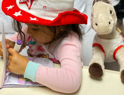 Coloring in a 4th of July Happy Hat at Levine Hospital