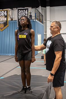 young girl in tumble class with coach.jpg