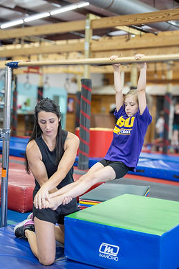 Girl on gymnastics bars.jpg