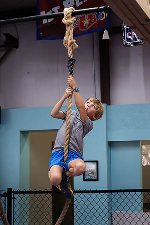 youth ninja climbing rope on rig.jpg