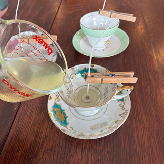 Pouring wax into vintage teacups