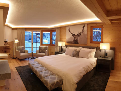 Spacious master bedroom with king-size bed, fireplace in Davos